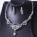 Detail shot of light blue teardrop crystal necklace and earrings set on black display - Silver Jelly Blue Rhinestone