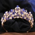 Macro shot of gold leaf crown detailing with white rhinestones and dark blue teardrop gems - KC Gold White & Sapphire Blue Rhinestone