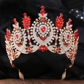 Macro shot of Baroque gold tiara featuring intricate red teardrop gems and white rhinestones - KC Gold White Rhinestone Red Stone (With Comb)