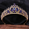 Detailed craftsmanship of golden crown featuring dark blue gems and white crystals - Gold with Clear and Royal Blue Rhinestones