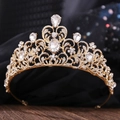 Close-up of golden bridal tiara featuring rhinestone leaves and pear-shaped crystals - KC Gold White Rhinestone