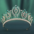 Detail of baroque bridal crown with green teardrop gemstones and golden alloy on emerald silk - KC Gold White Diamond + Green Diamond