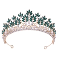 Detailed macro view of gold baroque crown featuring emerald green leaves and pearls - KC Gold White Diamond + Green Diamond