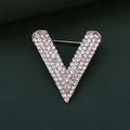 Macro shot of silver V-shaped brooch with inlaid rhinestones on green texture - Small / Silver