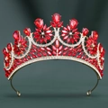 Detailed macro view of gold alloy bridal tiara with red crystals and white rhinestones - Gold/Red