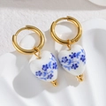Close-up of heart-shaped blue and white porcelain earrings with golden beads and hoops - Heart Shape (S-E1087)