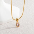 Detail of pink pear-shaped zircon pendant on a gold snake chain necklace over marble - Pink