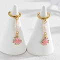 Detail of gold fish earrings with white freshwater pearl and pink gemstone charms - Pink Fish / Gold