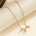 Detail view of golden necklace featuring geometric triangle charms and small white pearls - Triangle Artificial Pearl Style (S-N2241-B)