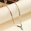 Bohemian colorful beaded necklace featuring a gold-edged blue seahorse charm and metal chain - Seahorse