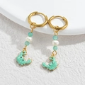 Ocean style gold drop earrings featuring green beads and a ceramic-textured crab pendant - Green Crab / Gold