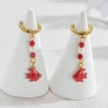 Golden hoop earrings featuring a vibrant red enamel fish pendant and a white pearl detail - Red Small Fish / Gold
