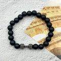 Close-up of black volcanic stone bracelet featuring a silver dumbbell bead with FIT engraving - Matte Stone Gunmetal