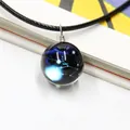 Macro shot of dreamlike galaxy sapphire glass ball necklace with handcrafted wire wrapping - Taurus