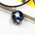 Detailed view of starry sky glass ball pendant with silver wire wrap and blue nebula motif - Capricorn