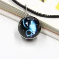 Detail of galaxy glass ball necklace with blue nebula pattern and silver wire wrapping - Aquarius