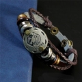 Détail du bracelet multicouche en cuir avec breloque zodiaque Poissons et cordons tressés - Poissons