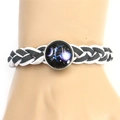Detail of hand-woven black and white cord bracelet with a purple nebula glass pendant - Libra / White