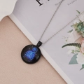 Detailed view of Scorpio zodiac necklace with luminous blue scorpion on black round pendant - Scorpio