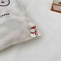 Close-up of a cute snowman enamel pin with a red hat on a white canvas bag - Snowman Style