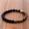 Matte black agate and wenge wood bead bracelet on a natural rustic timber background - Matte Black Stone And Wenge Wood