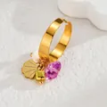 Close-up of golden bohemian ring with purple gemstone, scallop and cube charms - Purple Crushed Stone Style (S-R790-zb)
