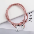 Close-up of pink braided astronaut couple bracelets with magnetic charm connection - Pink Pair