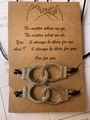 Detail view of woven friendship bracelets with freedom handcuff charm on a gift card - Handcuffs (BS-0007)