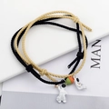 Detail of woven astronaut couple bracelets with adjustable cords and charms - Yellow And Black