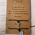 Detail of woven friendship bracelets with heart lock and key charms on a gift card - Key and Lock (BS-0007)