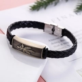 Detailed shot of retro braided leather bracelet with bronze plant leaf pattern charm - Hemp Leaf Pattern Style