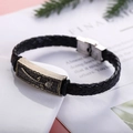 Detail of woven leather bracelet featuring a bronze rose engraved plate and steel clasp - Rose Flower Pattern Style