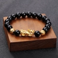 Detailed macro view of black obsidian beads and gold-plated Pixiu charm on the bracelet - BNS-0078-10mm Obsidian Style Pixiu