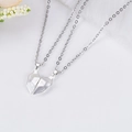 Detail of magnetic broken heart pendants for couples in polished silver-tone alloy - Wishing Stone White
