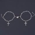 Detail view of heart magnetic clasp and cross charms on silver Figaro chain bracelets - NK 1:3 Cross