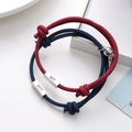Detail of magnetic couple bracelets with engraved metal bars and woven rope design - Wine Red And Navy Blue