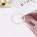 Bracciale di pietre naturali rosa con distanziatori dorati e cordino regolabile - Rosa