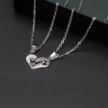Detailed macro view of heart puzzle necklace with I Love You engraved on polished steel - I Love You Puzzle Style (8)