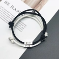 Matching braided couple bracelets with magnetic hearts and custom engraved characters - Black and White
