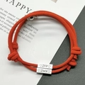Pair of red woven couple bracelets with engraved silver magnetic charms and adjustable knots - Red