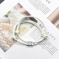 Matching cream white woven couple bracelets with silver engraved metal charms - White