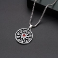 Detail of square twist chain necklace featuring a red gemstone sunburst pendant charm - Sun Necklace