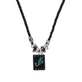 Detailed view of Scorpio constellation pendant on black cord necklace with silver accents - Scorpio