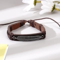 Bracciale artigianale in pelle intrecciata marrone scuro con ciondolo a foglia d'argento - Stile Piuma in Pelle Marrone