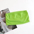 Flat lay of neon green elastic yoga headband on a magazine background with knit texture - Fruit Green
