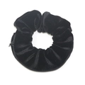 Black velvet scrunchie with hidden zipper pocket for small items storage on white background - Black
