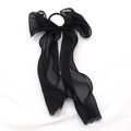 Elegant black chiffon bow hair scrunchie with long ribbons on white fabric background - Black