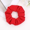 Macro detail of vibrant red scrunchie showing premium textured fabric and fine stitching - Bright Red