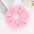Close-up of pink textured knit hair scrunchie with soft ruffled fabric and elastic band - Cherry Pink
