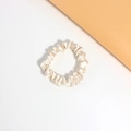 Detail of elegant champagne silk scrunchie with soft satin texture on white background - Beige